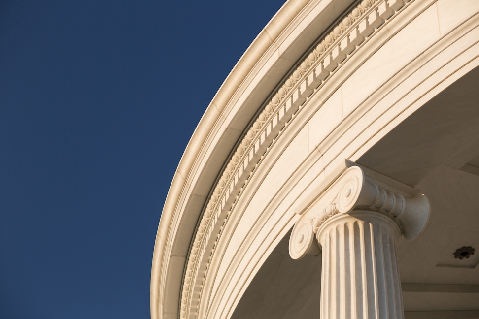 Solid structural marble — columns, entablature, cornice, pediment — the smallest piece five centimetres thick, every face curved to the radial plan.