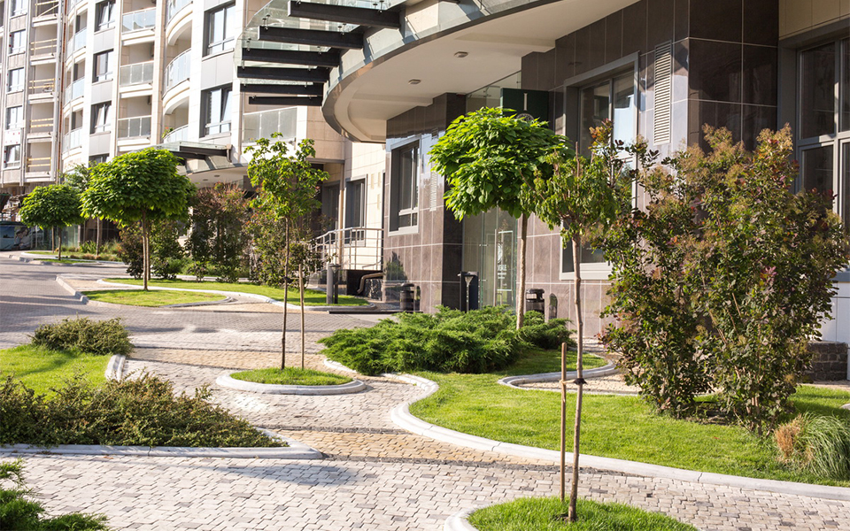 The car-free ground plane — landscaped walkways between the towers, where the industrial parcel had been.