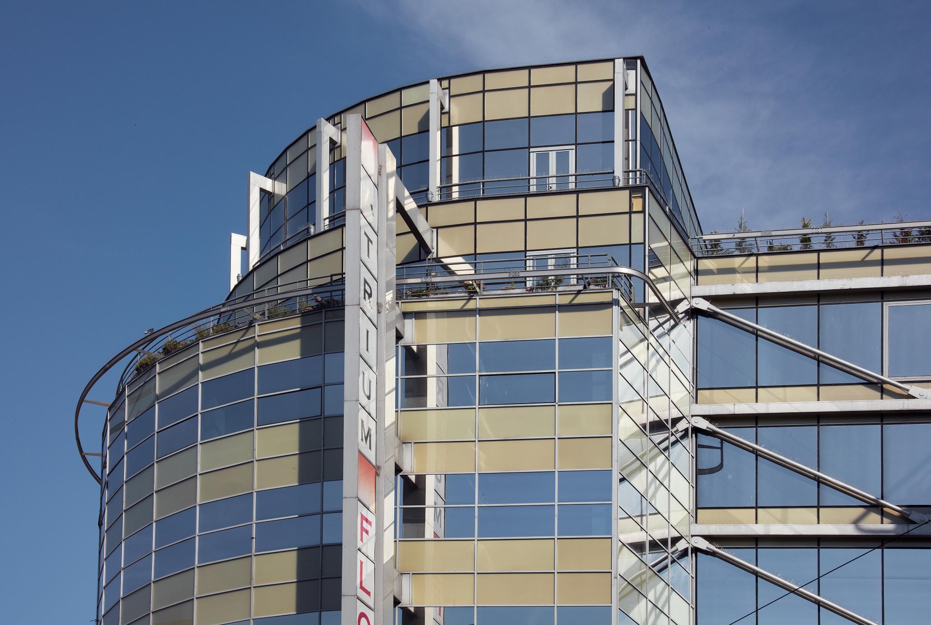 What there is now — the glazed Atrium Flóra frontage, one of the most successful mixed-use buildings in the Czech Republic, an anchor in Prague 3.